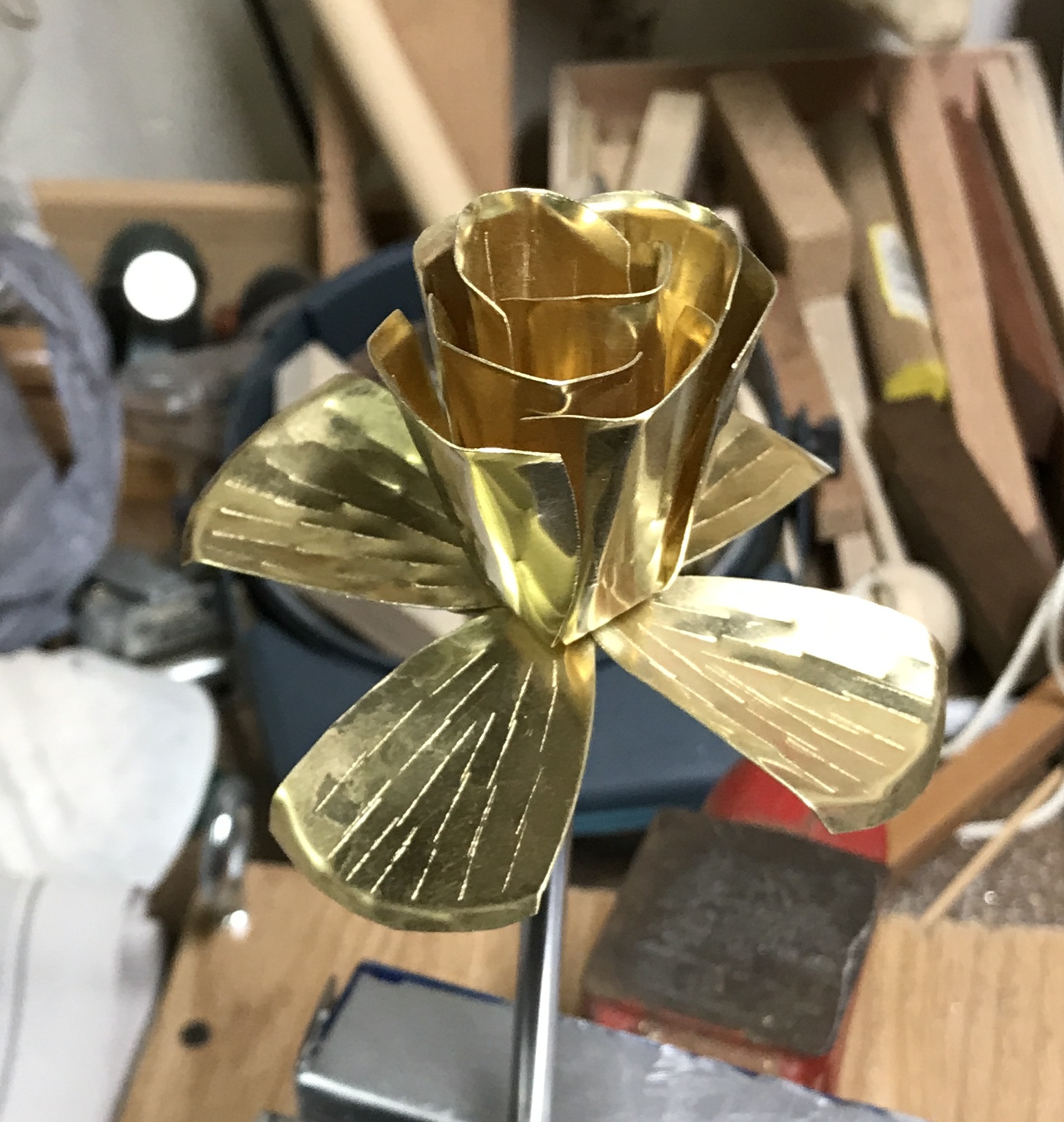 The brass rose after most petals bent